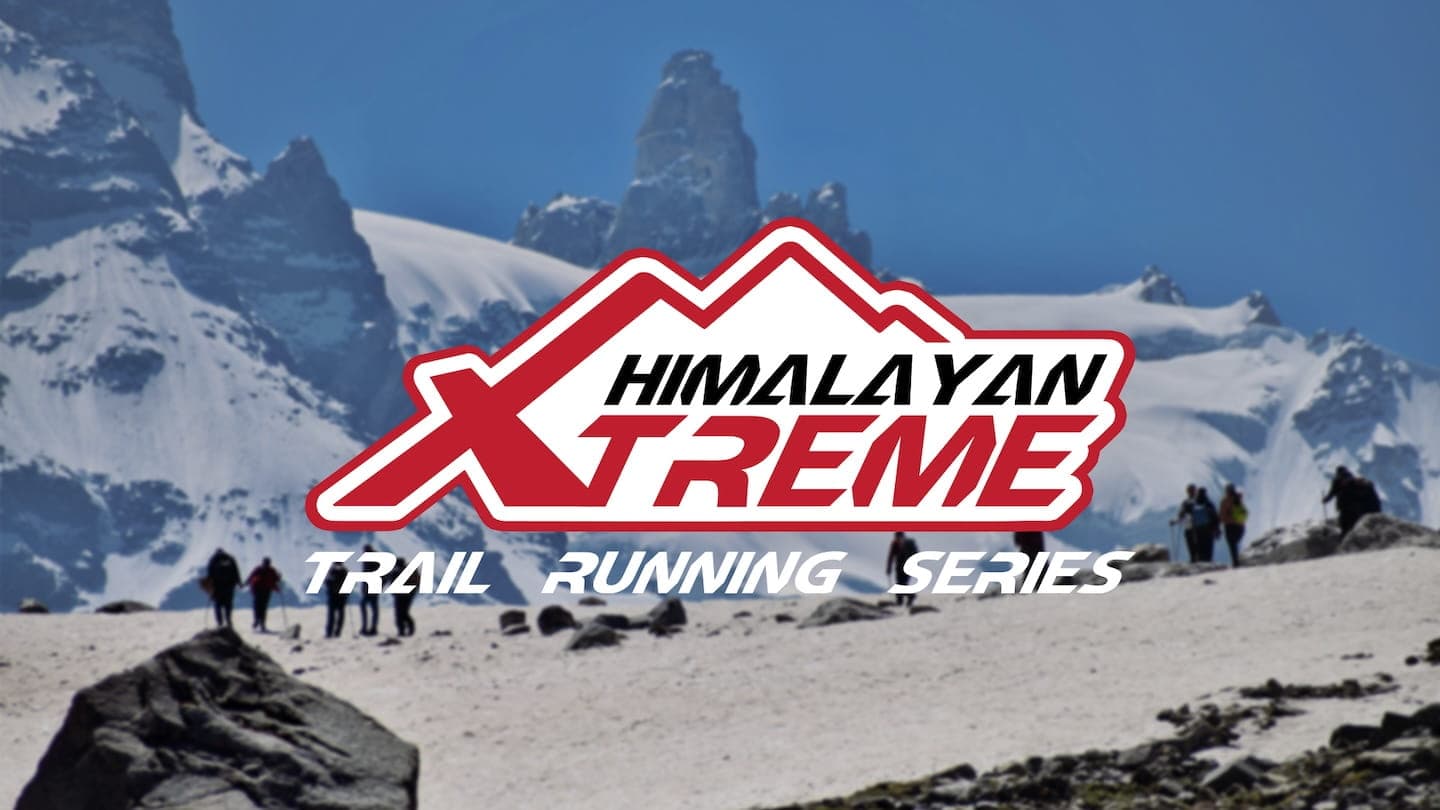 Trail runners crossing mountain terrain near Manali